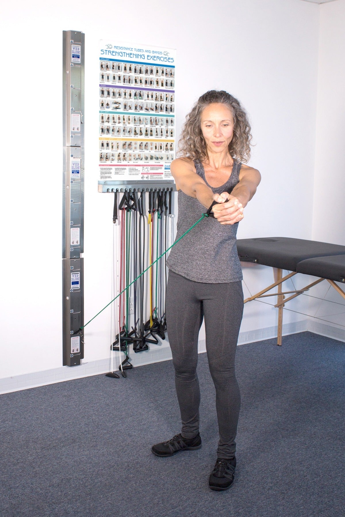 A person using a 3 ft. Unilateral Loop with Handle Heavy Resistance hooked up to a webslide in a training room